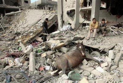 Mohammed Salem/Reuters Palestinians sit beside a dead horse after an Israeli air strike in Jabalya in the northern Gaza Strip, January 2, 2009. (Mohammed Salem/Reuters)